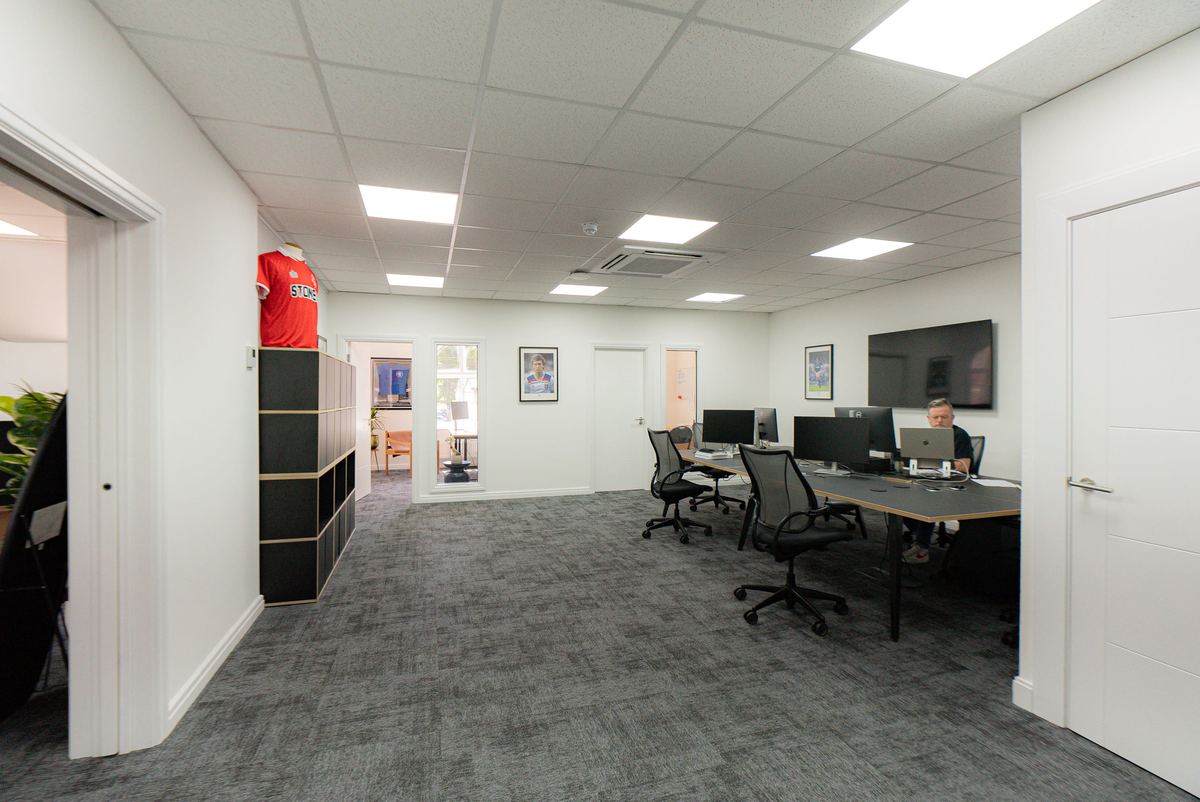 Open plan office fit-out with desks and partitioned rooms